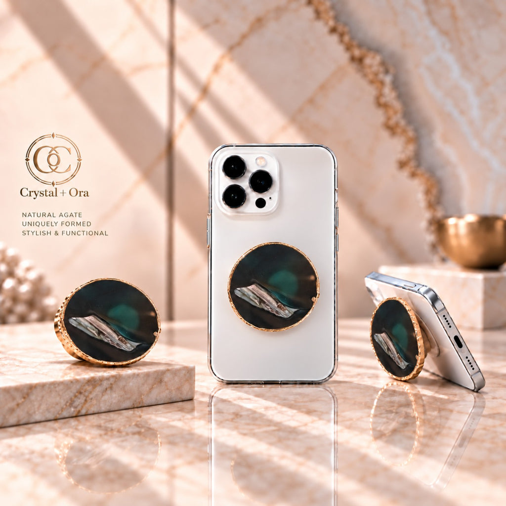 Black agate adhesive phone grip with gold-tone edging on white phones