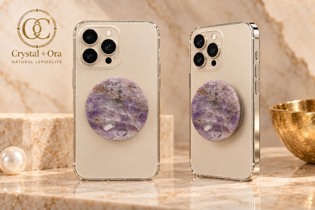 Round lavender lepidolite Halo phone grip with pale mineral markings on two light-colored phones