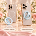 Pale blue silicone phone ring showing its white magnetic underside and attachment to a compatible case