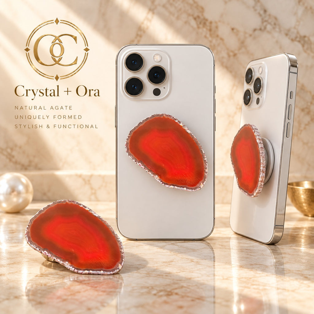 Red-orange agate MagSafe phone grip with subtle banding and a freeform shape on white phones